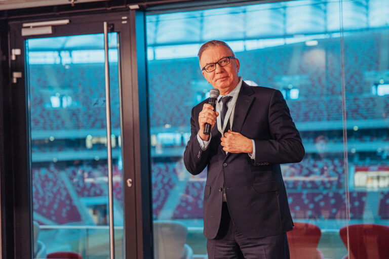Mężczyzna przemawia na stadionie z mikrofonem
