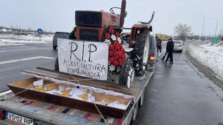 Protest rolników z trumną i traktorem na ulicy.