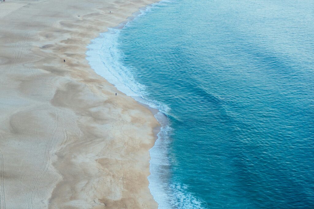 Widok na piaszczystą plażę i błękitne morze.