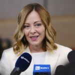 Kobieta udziela wywiadu przed mikrofonami.